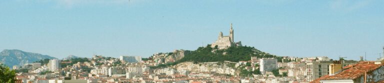 Scenic view of Marseille, France, featuring Notre-Dame de la Garde on a sunny day.