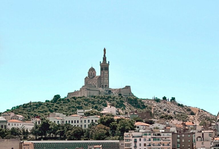 Beautiful view of Notre-Dame de la Garde overlooking the city and marina in Marseille, France.